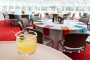 A cocktail sitting on a table with the Kauffman Center's interior in the background.