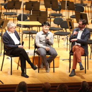 Music Director Michael Stern (on the far left) sits with two guests.